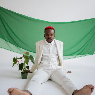 Fashionable black man with anthurium flower in studio